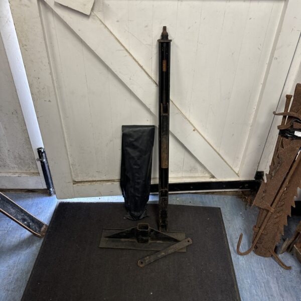 Vintage Land Rover jack with canvas cover, showing signs of age.