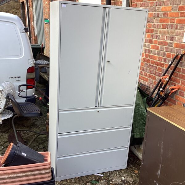 Large metal garage storage unit for tools and equipment.
