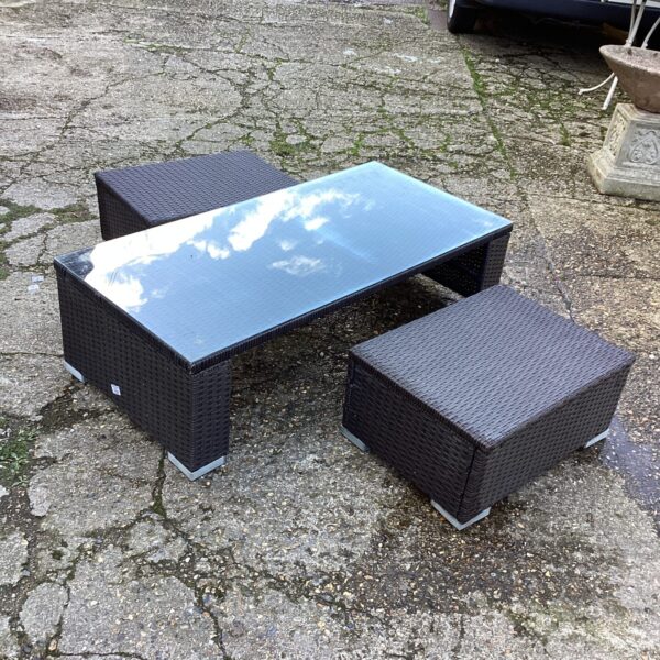 Woven raffia coffee table and stool for outdoor garden use.