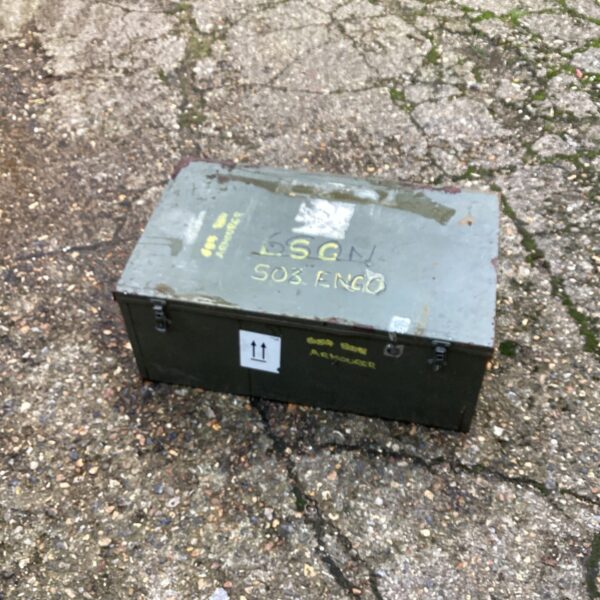 Vintage metal armoury chest with a hinged lid, showing signs of wear.