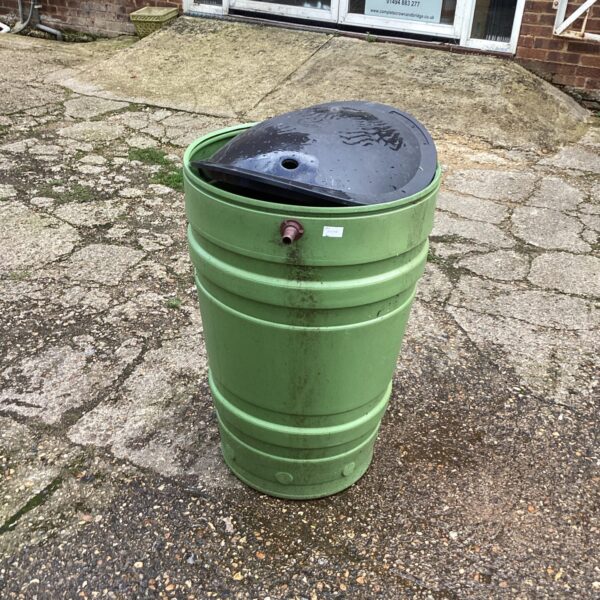 Green plastic garden water butt for rainwater collection.