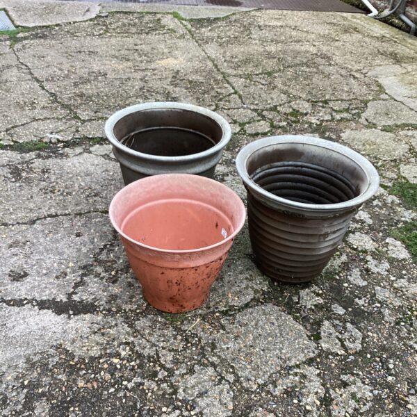 Lot of three terracotta garden planters for outdoor use.