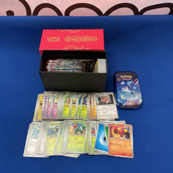 Pokemon card lot and tin for collectors and players.