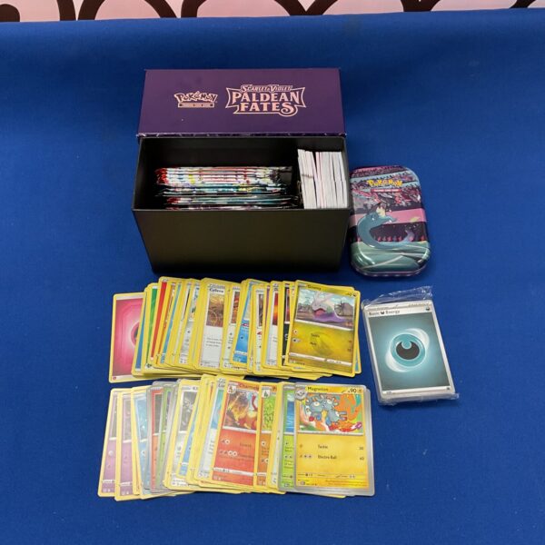 Pokemon card lot with a tin for storage and collection.