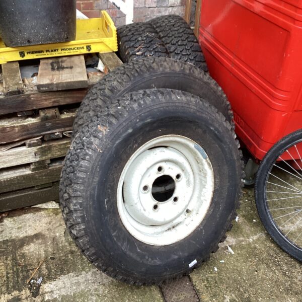 Set of four Land Rover wheels and tyres for restoration.