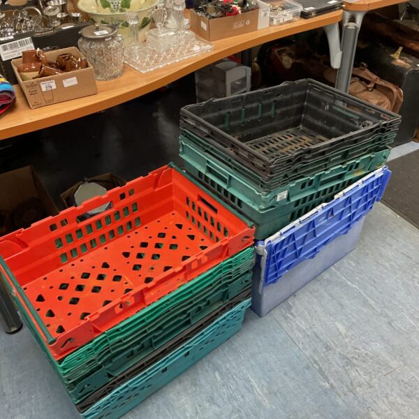 Lot of ten colourful plastic storage crates for household organisation.
