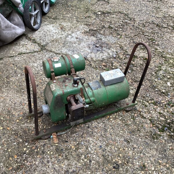 Green vintage air compressor for workshop or automotive use.