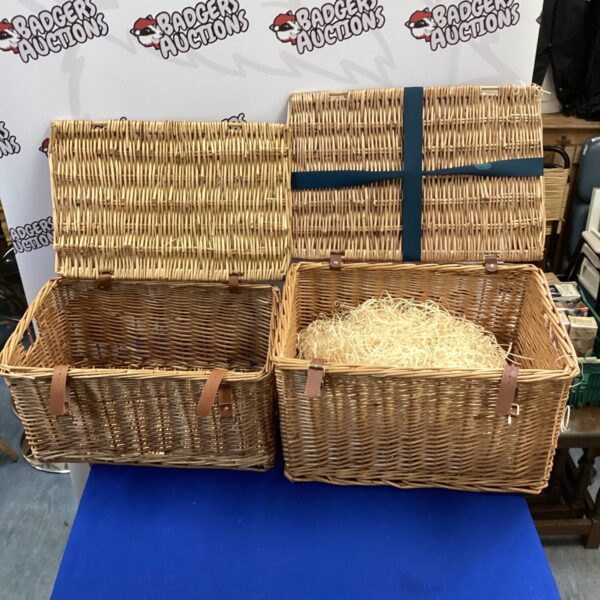 Vintage wicker picnic basket set with handles, ideal for outdoor use.