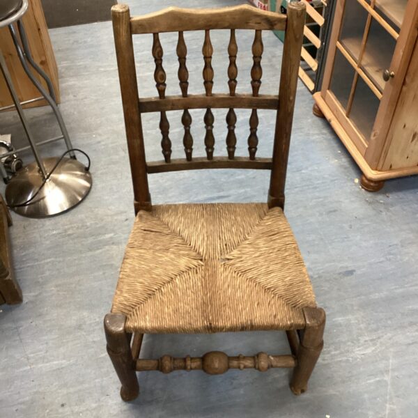 Antique Lancashire country chair with rush seat, front view.