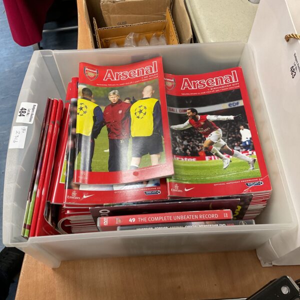 Mixed lot of vintage Arsenal football programmes and DVDs for collectors.
