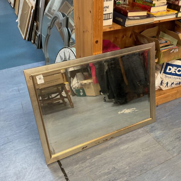 Large silver framed mirror with ornate detailing.