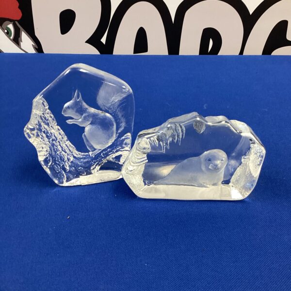 Detailed etched glass squirrel and seal ornaments for collectors.