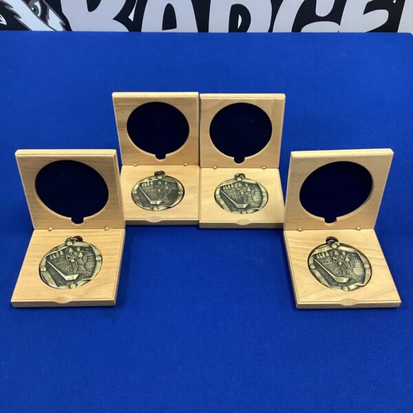 Set of four new gold-tone golf medals for sports awards.