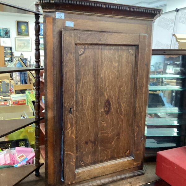 Antique Georgian oak corner cabinet with moulded cornice.