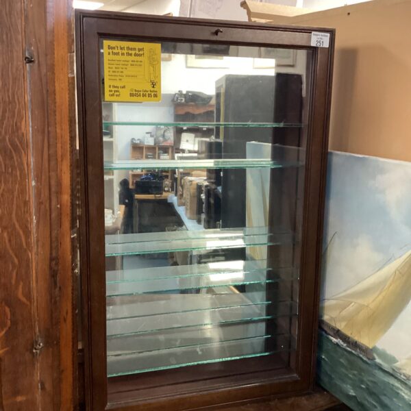 Vintage mirrored display cabinet showcasing antique collectibles.