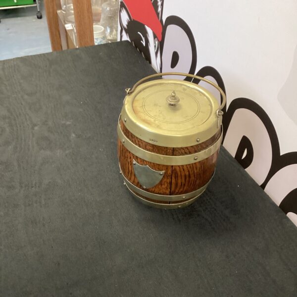 Vintage metal ice bucket with embossed pattern and handles.