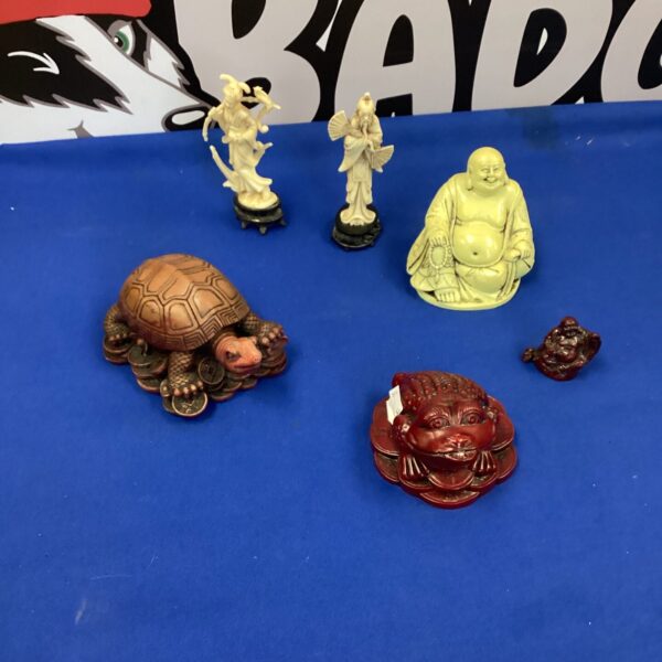 Oriental figurines collection featuring Buddha statues and money charms.