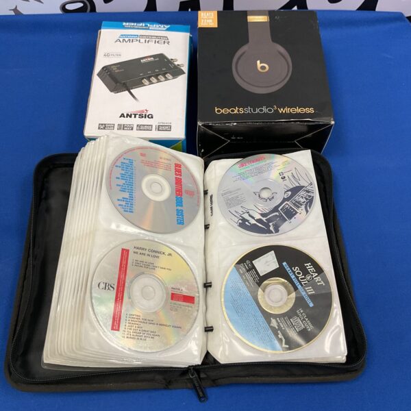 Beats Studio 3 wireless headphones with CD collection and amplifier.