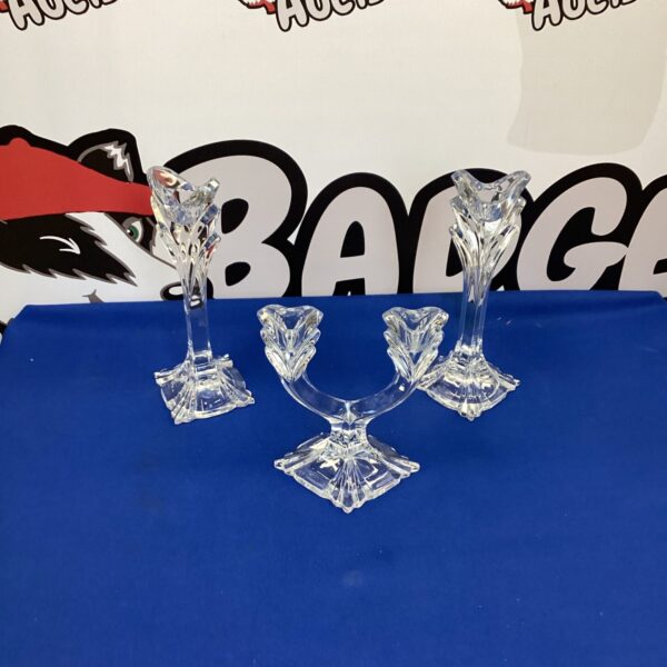 Set of three clear crystal candle sticks for home decor.