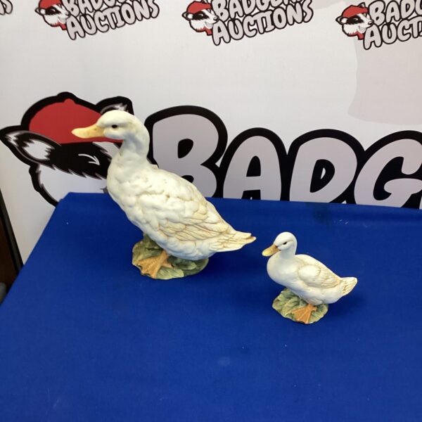 Pair of delicate porcelain duck ornaments for home decor.
