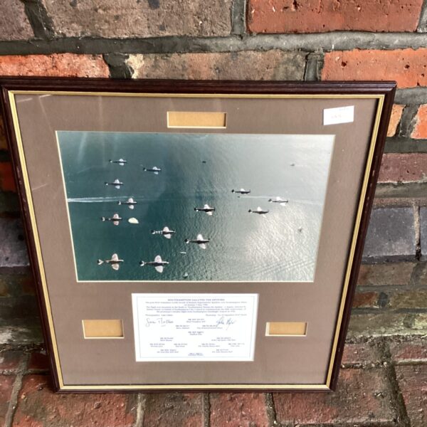 Framed Spitfire art print depicting aircraft over Southampton.