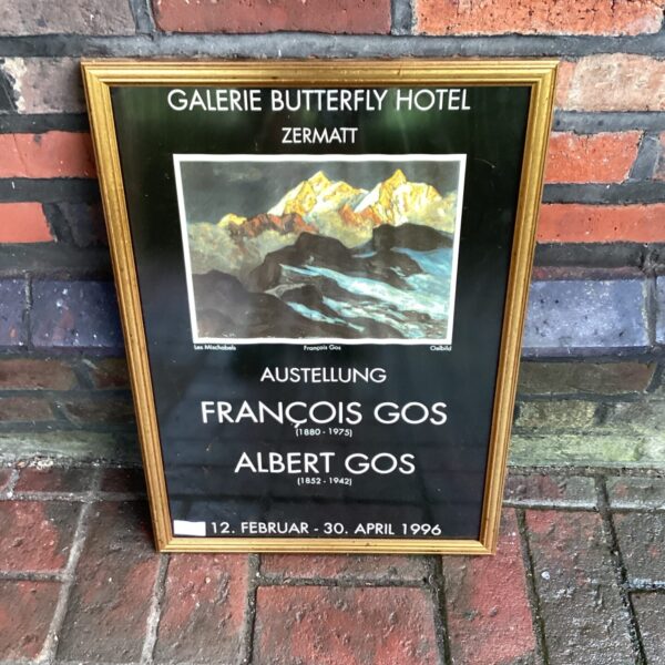 Framed vintage Galerie Butterfly Hotel poster with mountain landscape.