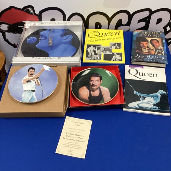 Vintage Queen collectors plates, wall clock, and books collection.