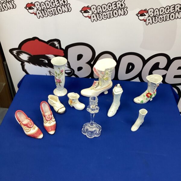 Miniature porcelain shoes and boots collection for display.