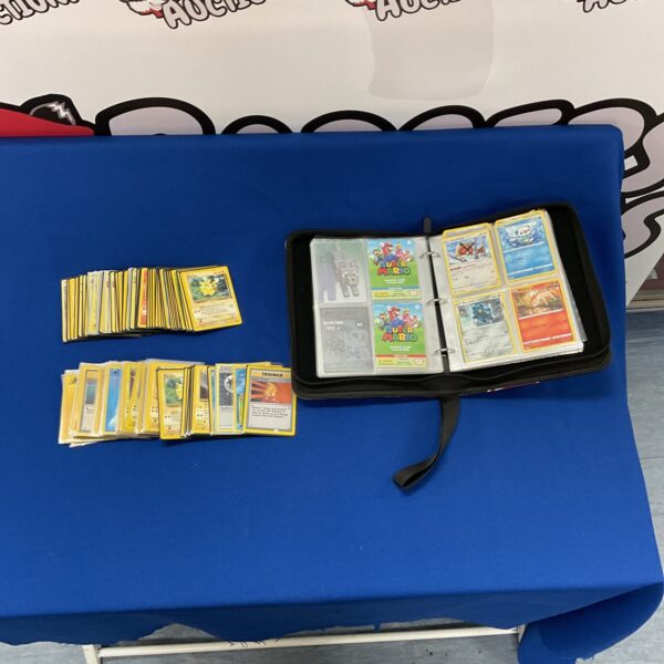 Pokemon card collection in a binder with various trading cards.