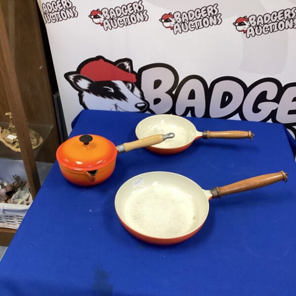 Vintage orange enamel Descoware frying pan with cast iron construction.