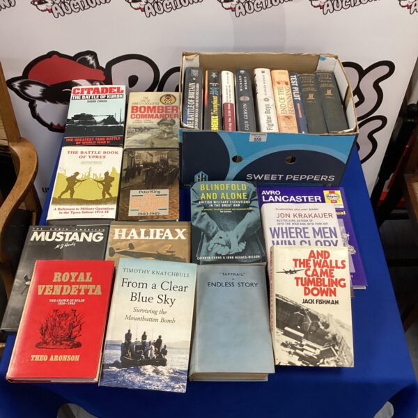 Vintage WWII book collection with various military history titles.