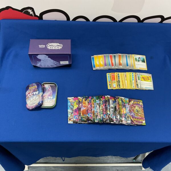 Pokemon card lot with opened booster packs and tin.