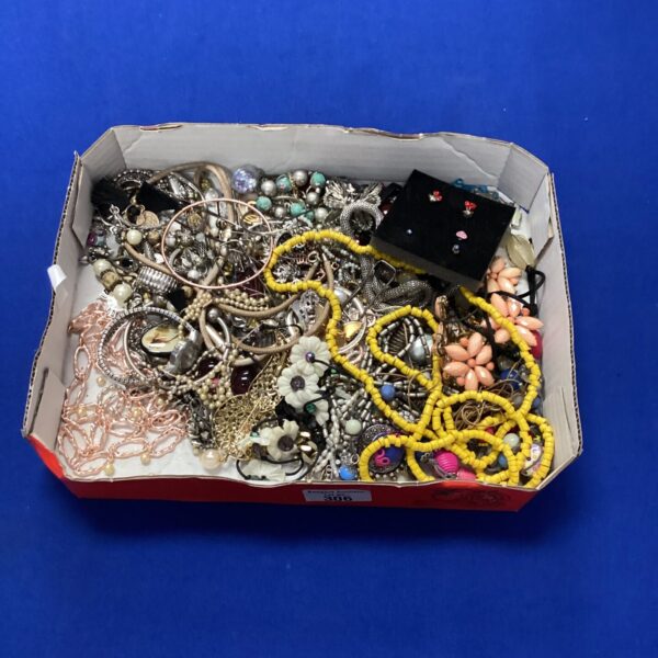 Colourful tray of vintage and fashion costume jewellery.