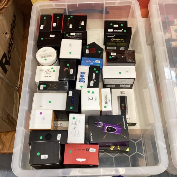 Assorted vape rigs from Voopoo, Smok, and Vaporesso in a storage container.