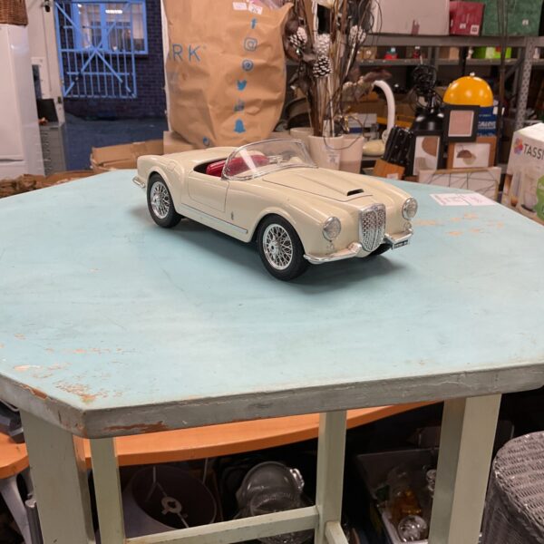 Detailed Burago Lancia Aurelia Spider model car on display.