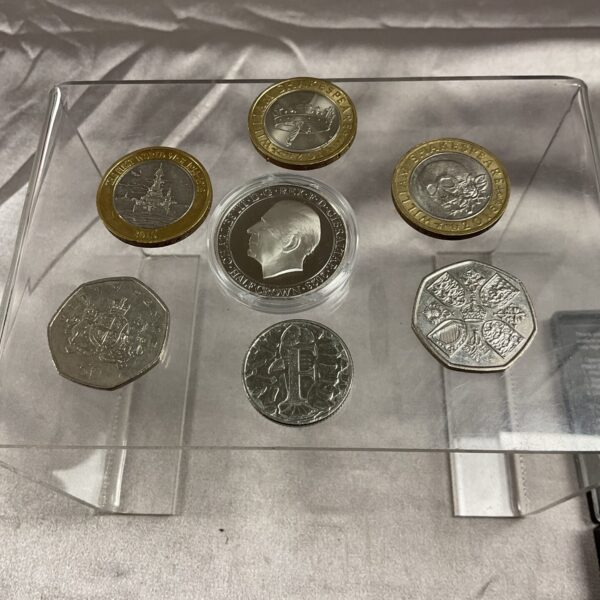 Close-up of a commemorative coin collection including a Charles half crown.