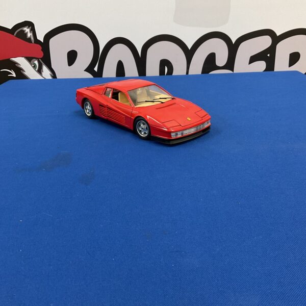 Red 1984 Ferrari Testarossa diecast model car on display.