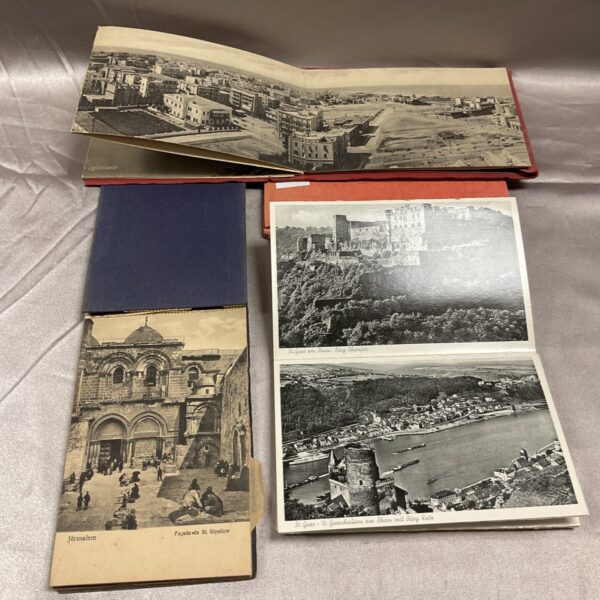 Vintage postcard books featuring scenes of Port Said and Jerusalem.