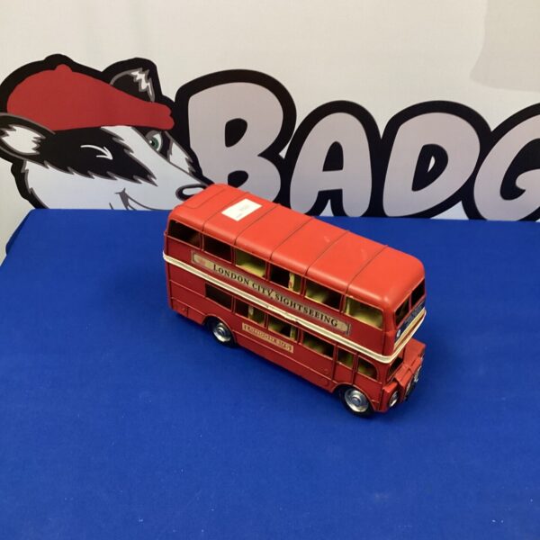 Vintage red tin plate London bus collectible toy.