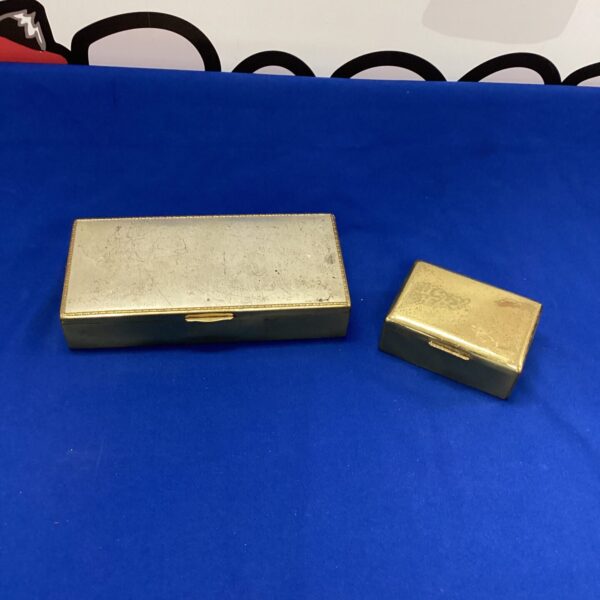 Pair of vintage metal cigarette boxes, collectible smoking accessories.