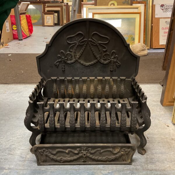 Antique Victorian cast iron fire grate for a fireplace hearth.