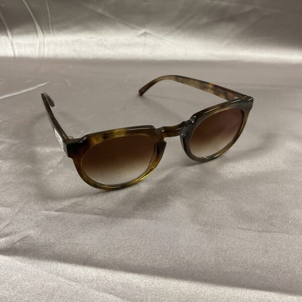 Stylish Laura Imami tortoise shell sunglasses with dark lenses.