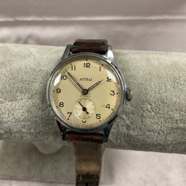 Vintage Astral wristwatch with leather strap and Arabic numerals.