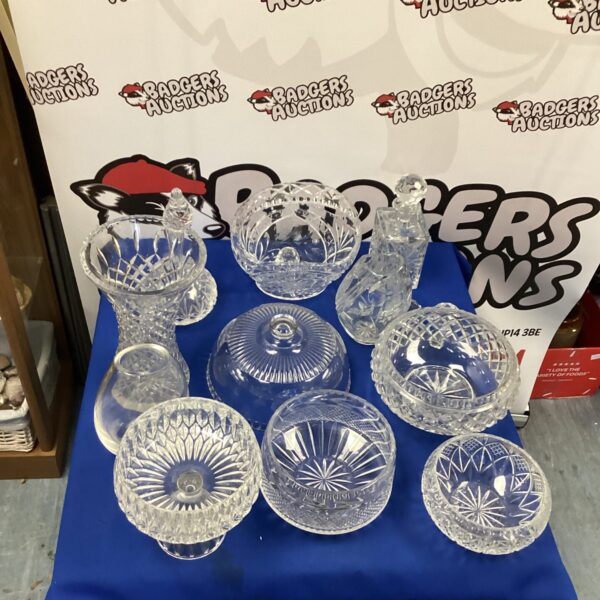 Selection of vintage crystal vases and bowls on display.