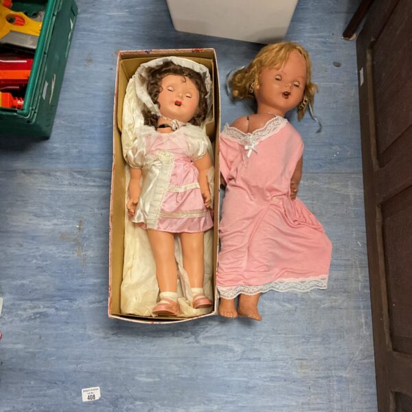 Vintage bisque dolls presented in their original cardboard box.