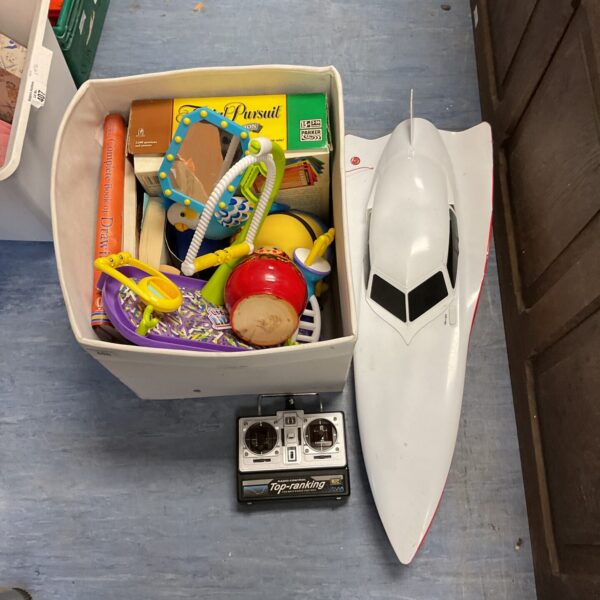 Mixed lot of toys, books, and a Trivial Pursuit game.