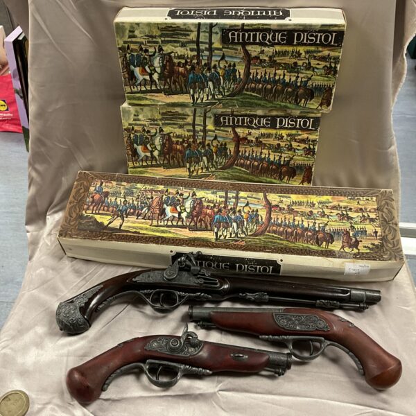 Three boxed replica flintlock pistols for collectors.