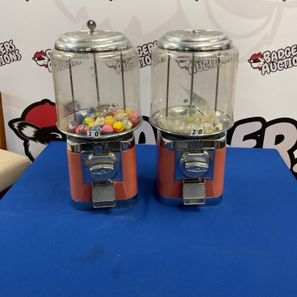 Pair of vintage gumball machines with keys, classic candy dispensers.