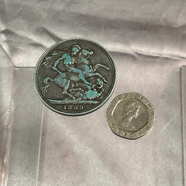 Front view of 1889 Victoria Silver Crown coin with Saint George design.