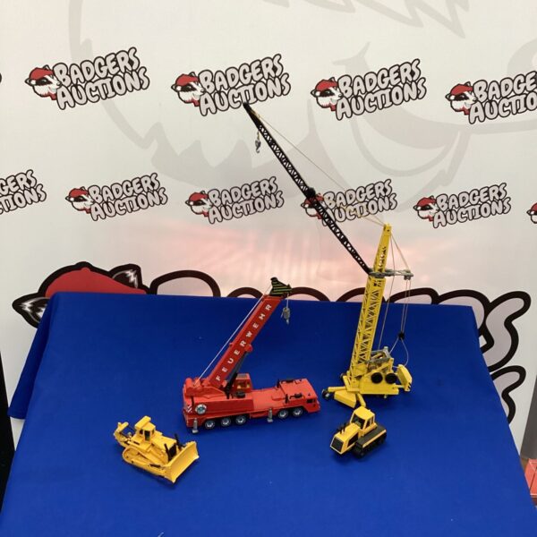 Red and black diecast construction model crane for collectors.